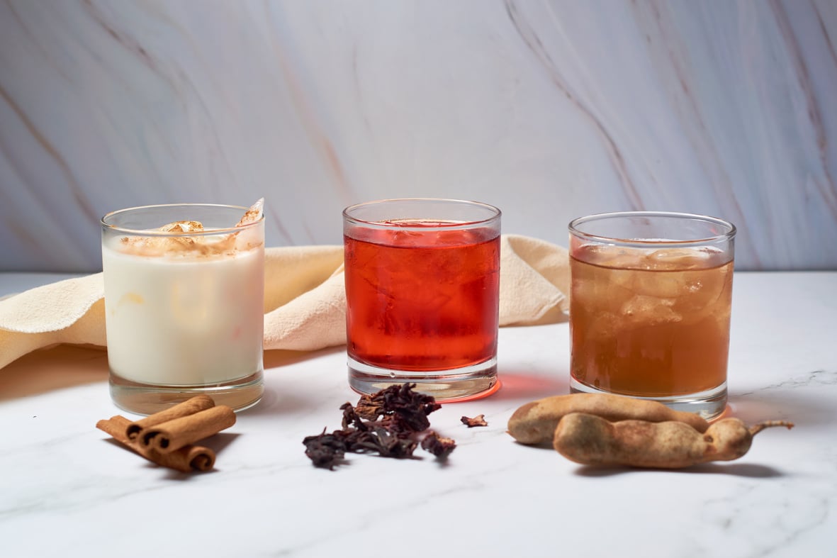 Traditional aguas frescas, Mexican flavored drinks, horchata, hibiscus and tamarind.